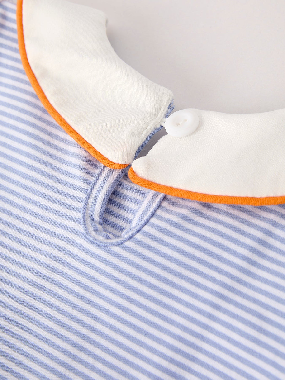 Girls striped dress sleeve with button cuff and orange trim around collar