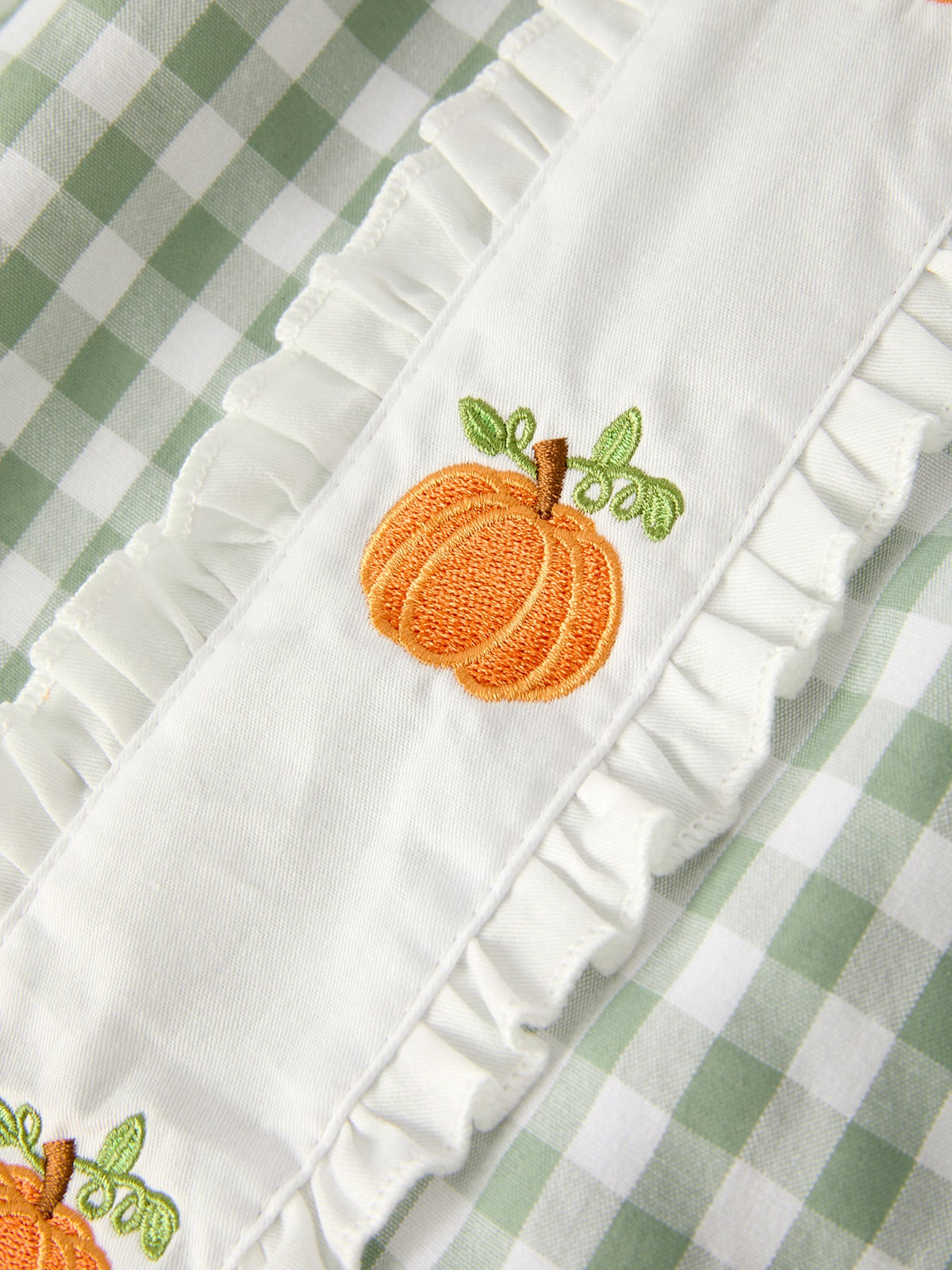 White ruffle trim with embroidered orange pumpkin applique and green leaves