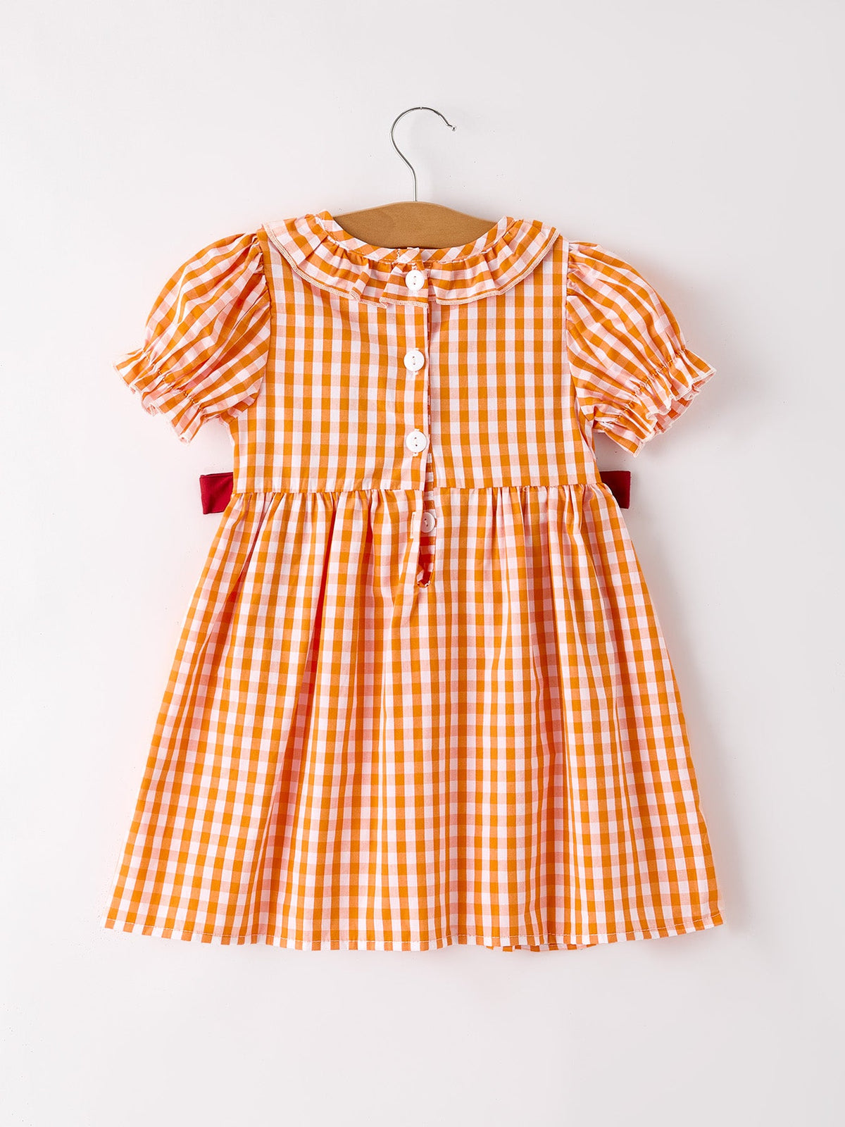 Girls orange and white checkered dress with puff sleeves and button front