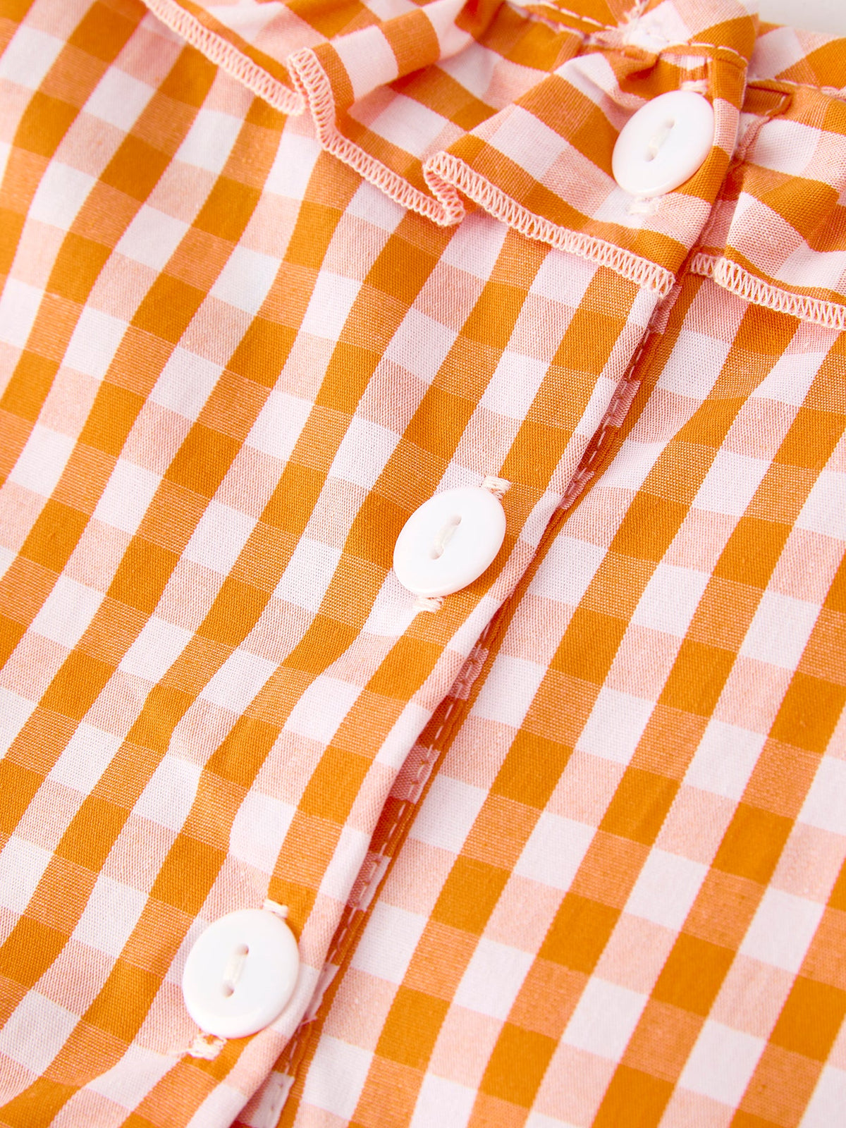 Girls orange checkered dress with white button front and orange piping