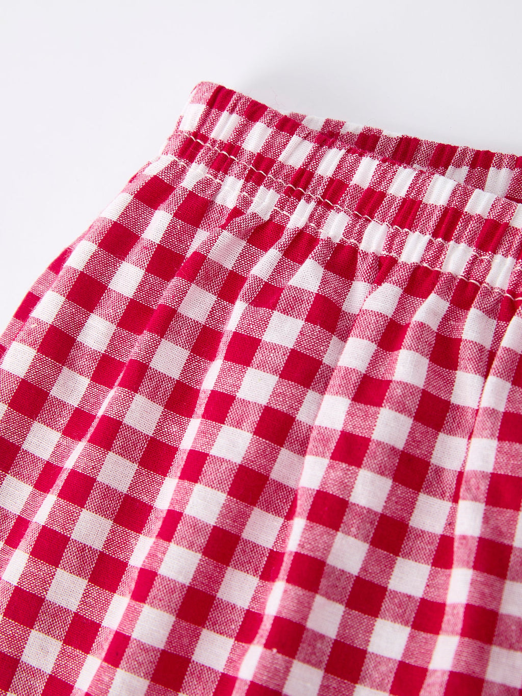 Red and white gingham plaid fabric with elastic waistband detail for boys pants