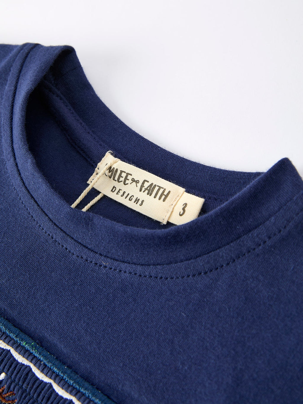 Navy boys T-shirt neckline with size tag and crewneck seam detail