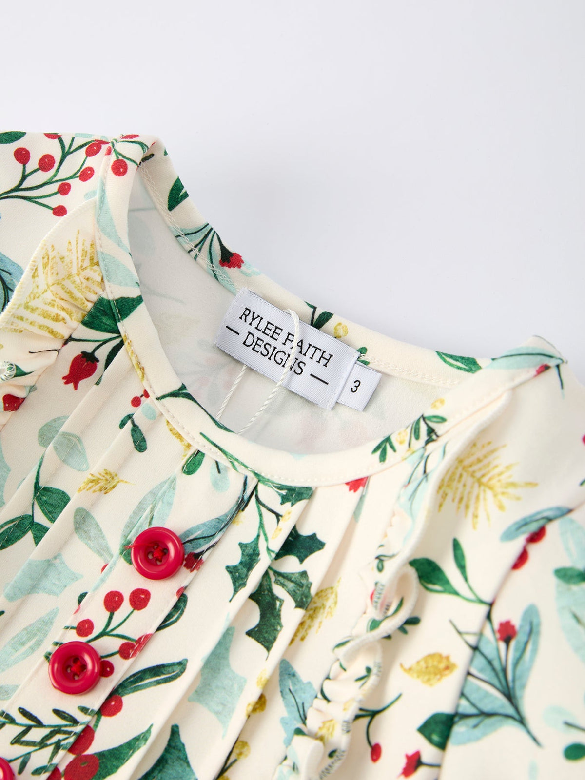 Cream toddler Christmas dress neckline with holiday floral print and red buttons