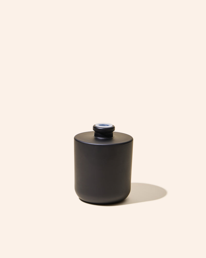 Aura® diffuser bottle in matte black with small opening on top