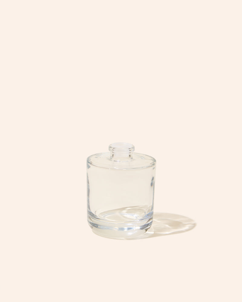 Aura® diffuser bottle in translucent clear glass with round top
