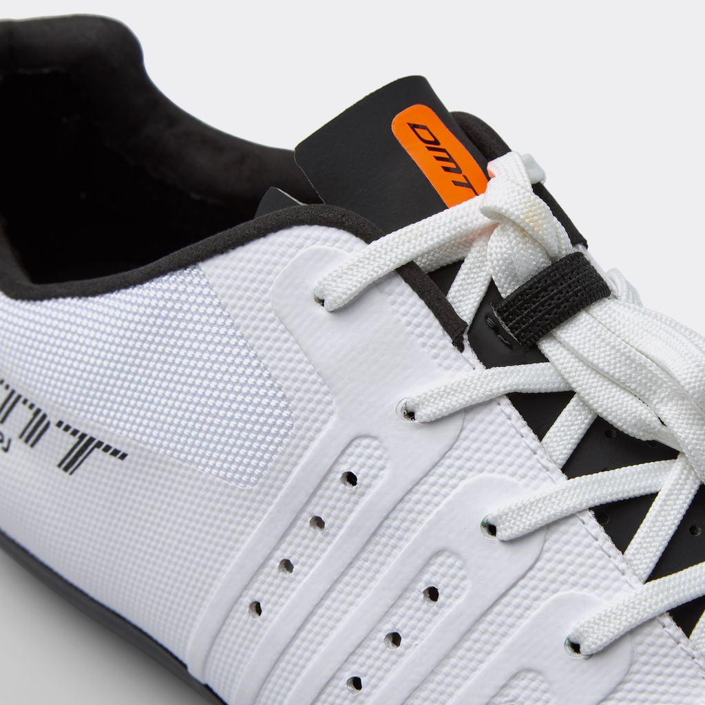 Close-up of white road cycling shoe tongue, laces, and orange brand tab