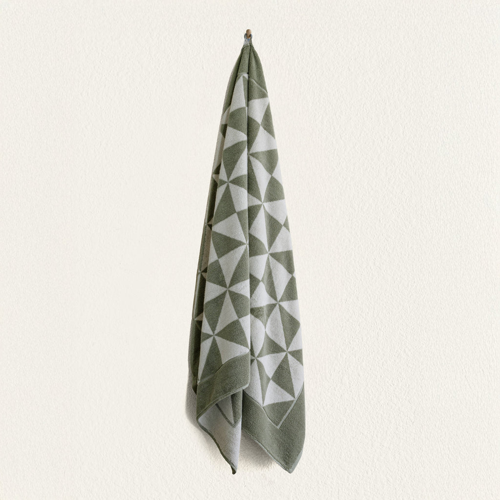 Sage and ecru geometric cotton hand towel hanging from top loop