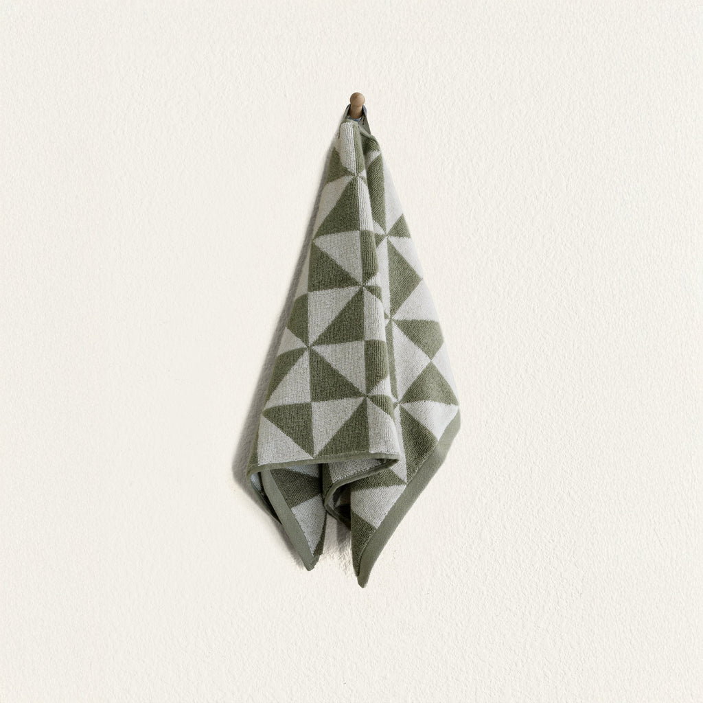 Sage and ecru geometric cotton hand towel folded, hanging loop at top