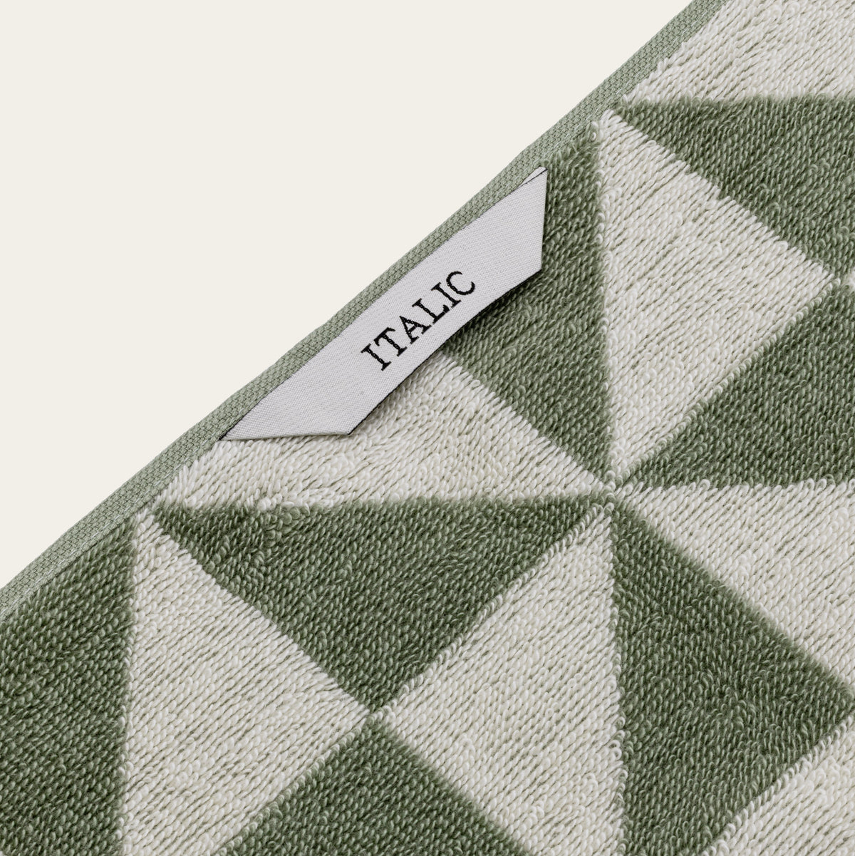 Sage and ecru geometric cotton towel with ITALIC label and stitched border