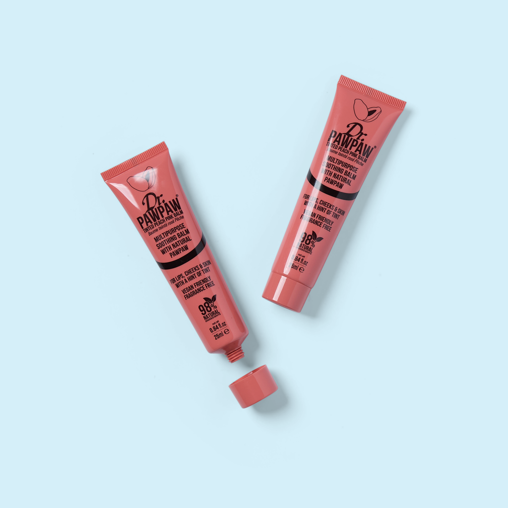 Two pink squeeze tubes with caps and printed skincare labels
