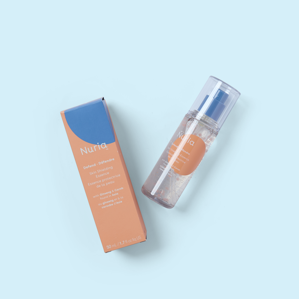 Nuria body mist bottle with orange liquid and matching blue carton