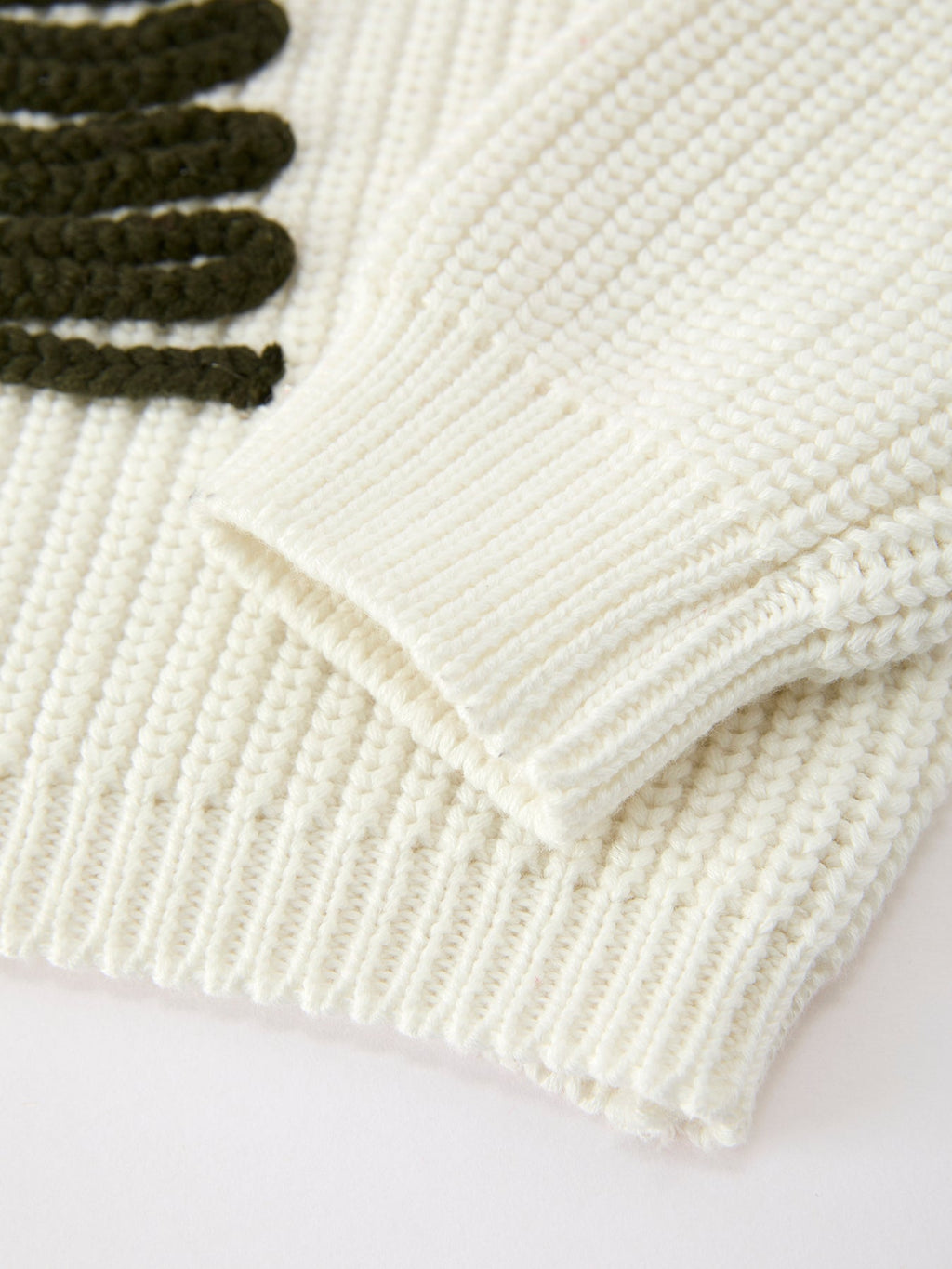 Cream ribbed hem and cuffs on knit girls pullover sweater