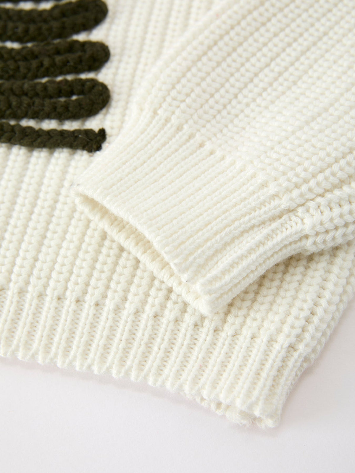Cream ribbed hem and cuffs on knit girls pullover sweater