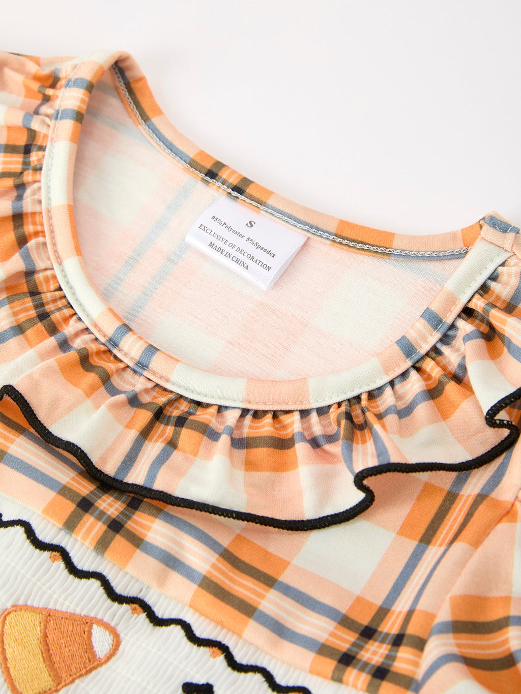 Girls plaid dress rounded neckline with cream trim and black-edged ruffle