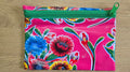 Pink floral zippered pouch with green zipper and colorful blossoms