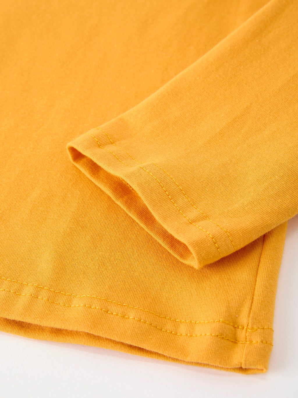 Yellow long-sleeve shirt sleeve and hem with stitched cuff