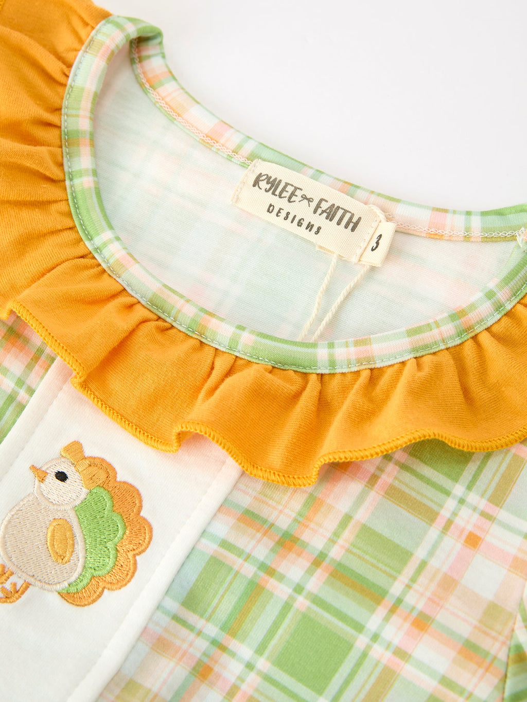 Girls plaid yoke with turkey applique at chest and orange ruffle neckline