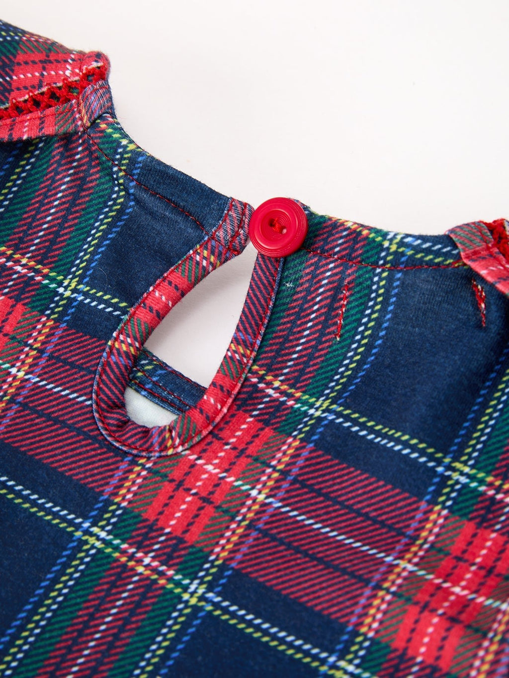 Plaid dress yoke with red button and keyhole neckline, red navy green tartan