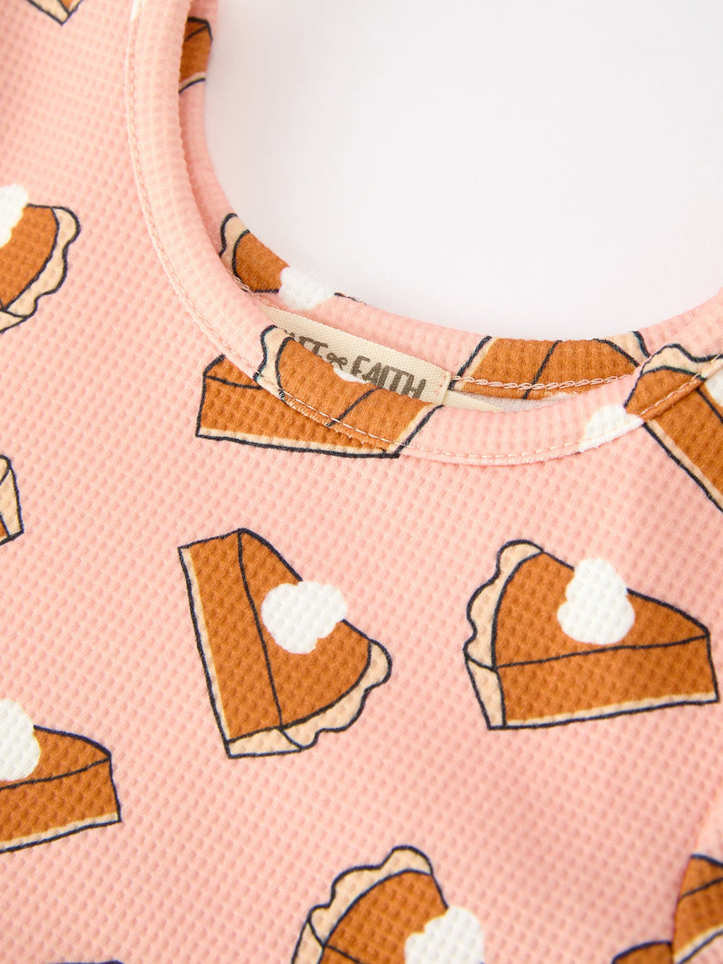Girls pink pumpkin pie patterned dress, curved neckline close-up