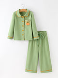 Kids' green pajama set: button-front top with pumpkin chest pocket and drawstring pants