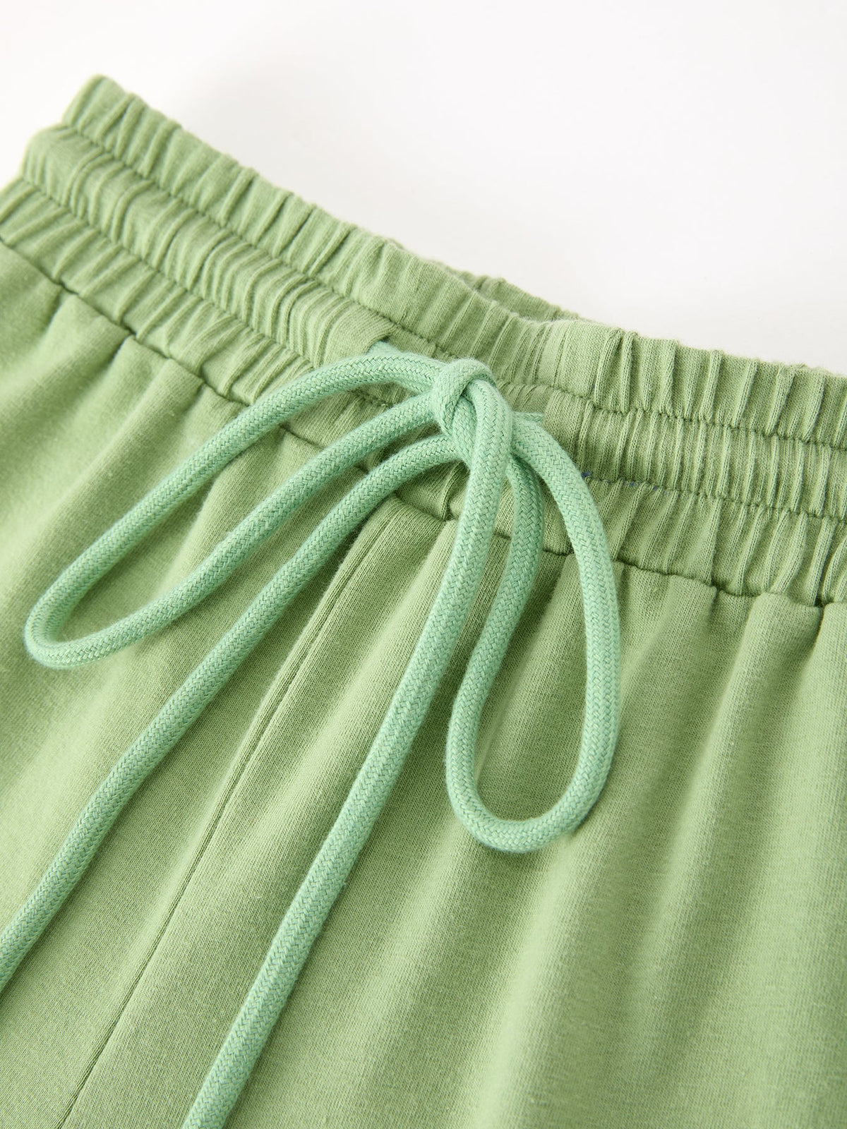Kids' green pajama pants with elastic waist and light-green drawstring