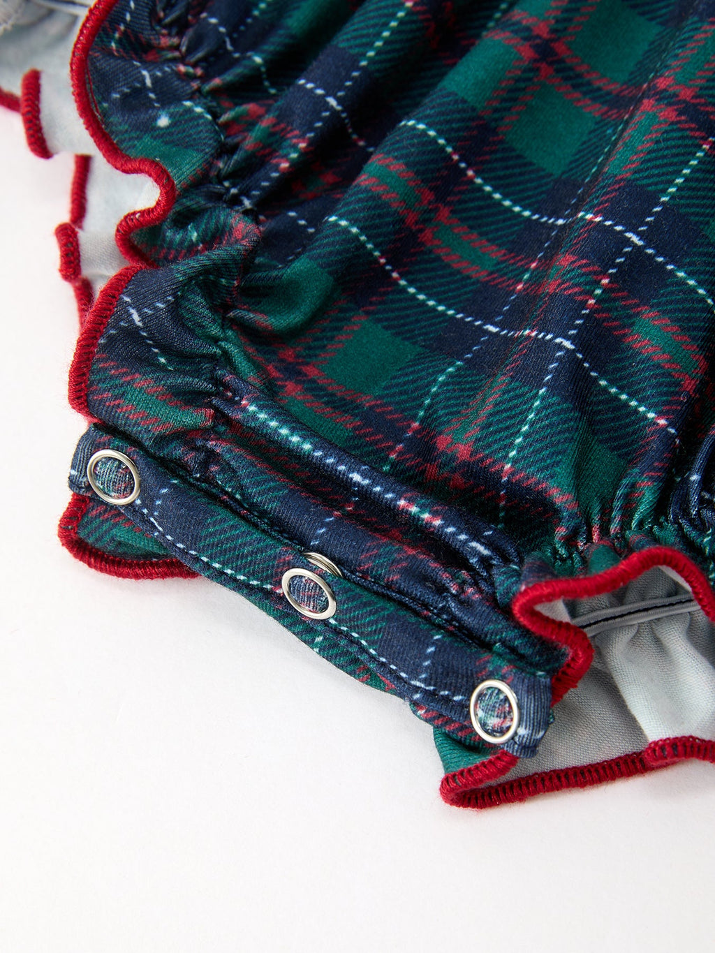Girls plaid bubble romper with red ruffled edge and metal snap legs