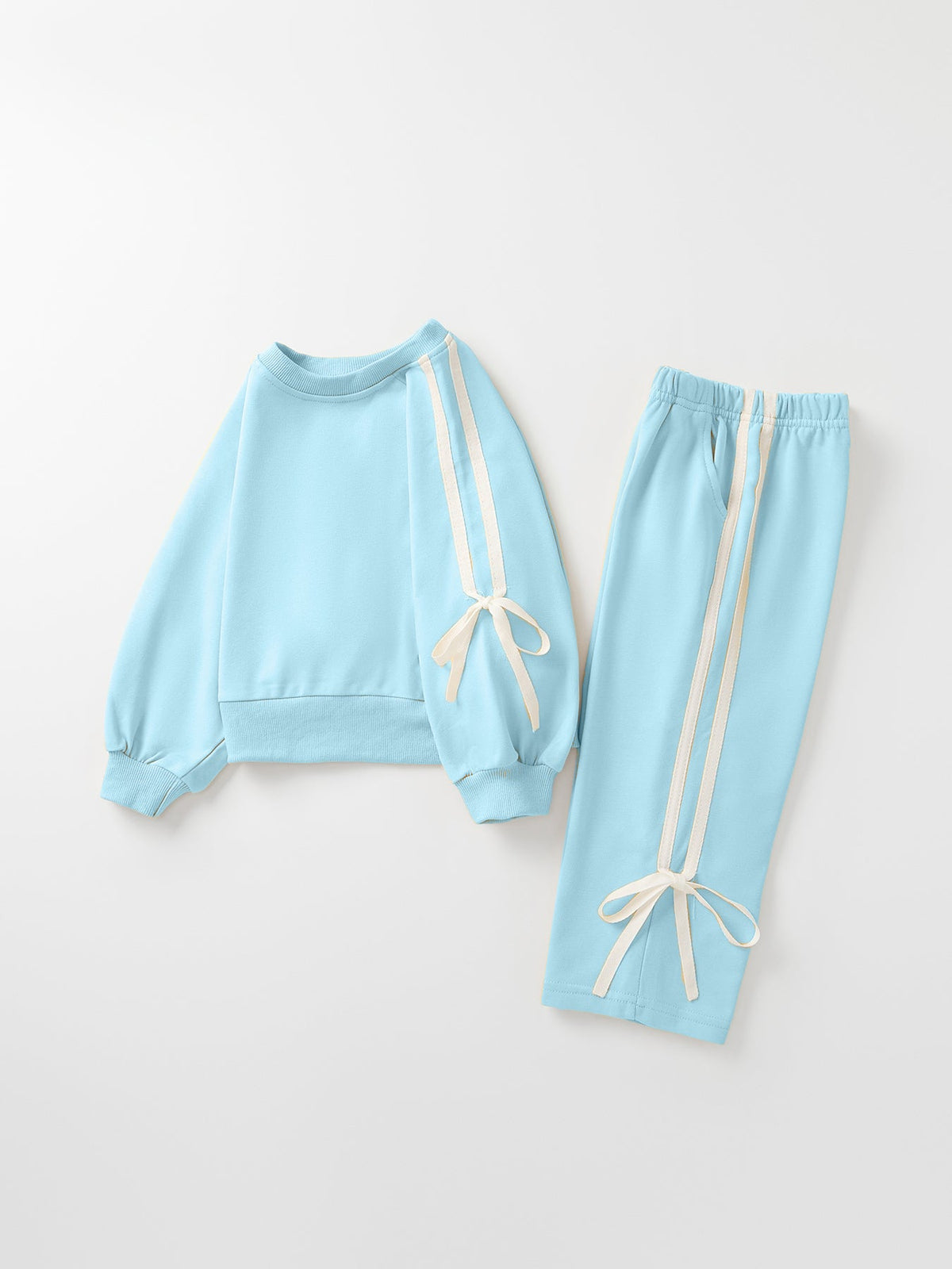 Girls light blue sweatshirt and pants set with bow-tie ribbons and side stripes