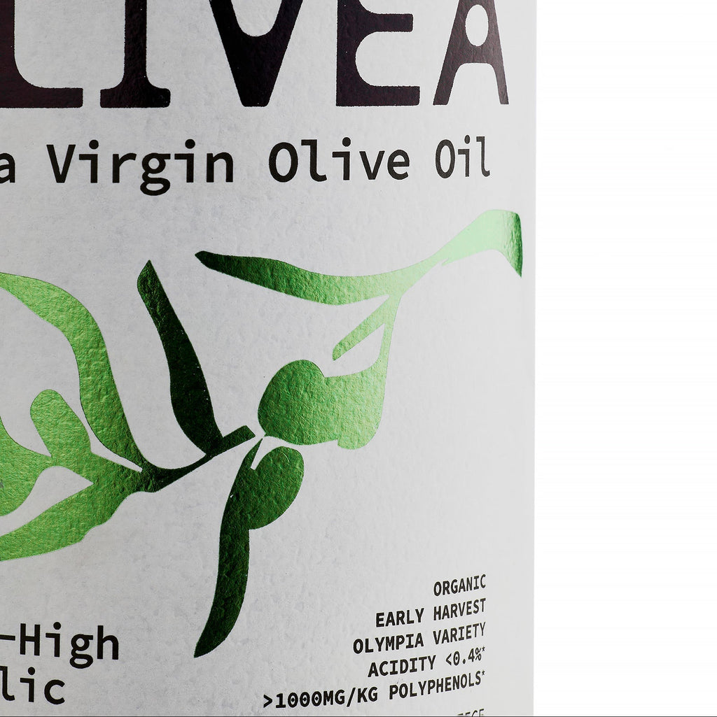 Extra virgin olive oil label close-up with green leaf graphics and organic text