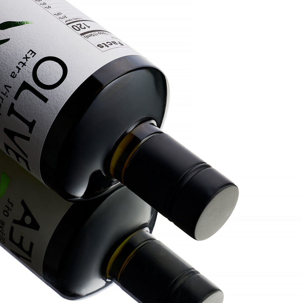 Olive oil bottle neck with black spout and glossy dark label in close-up