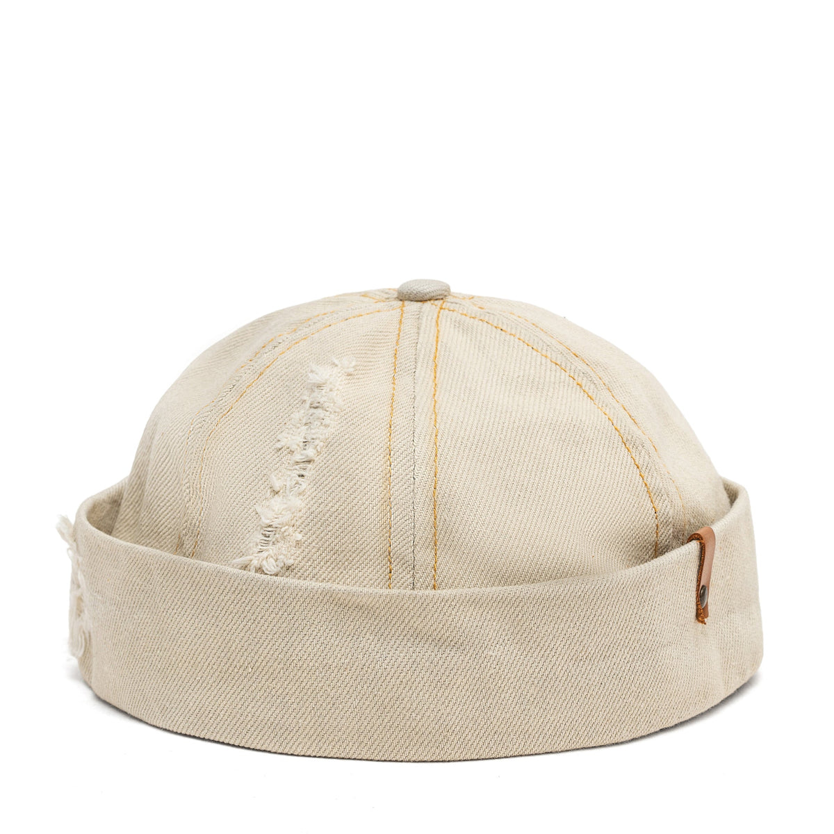 Beige canvas Docker-style cap top with vertical seams and small distressed embroidery