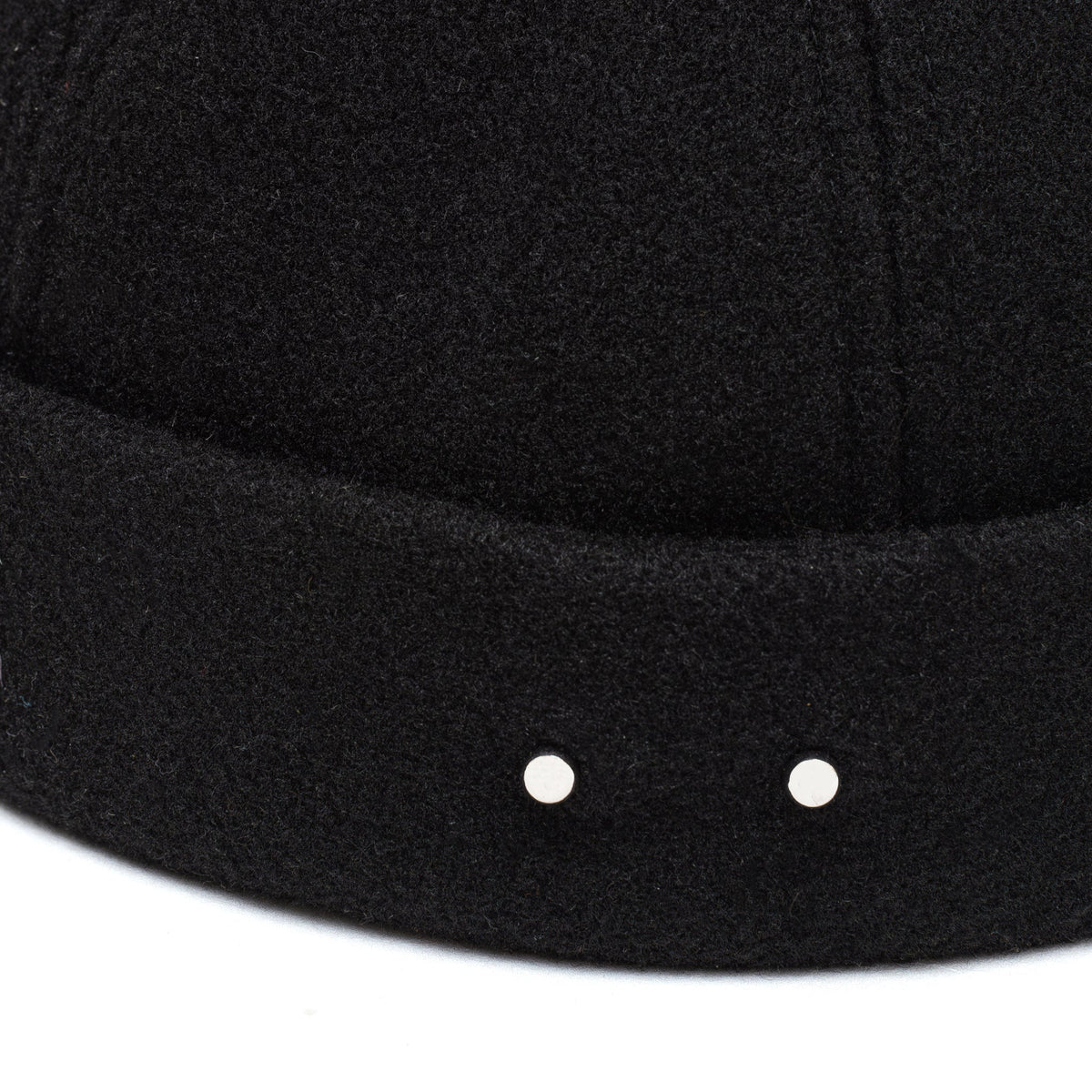 Black docker cap brim with two metal stud details