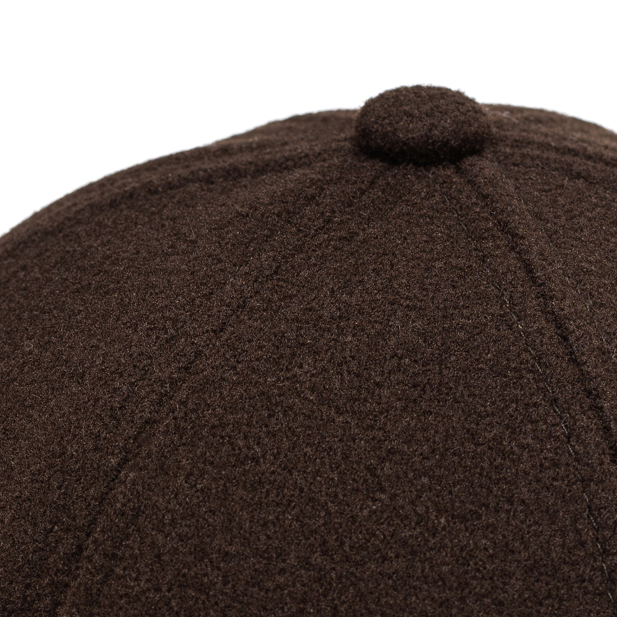 Dark brown felt cap close-up with textured fabric top