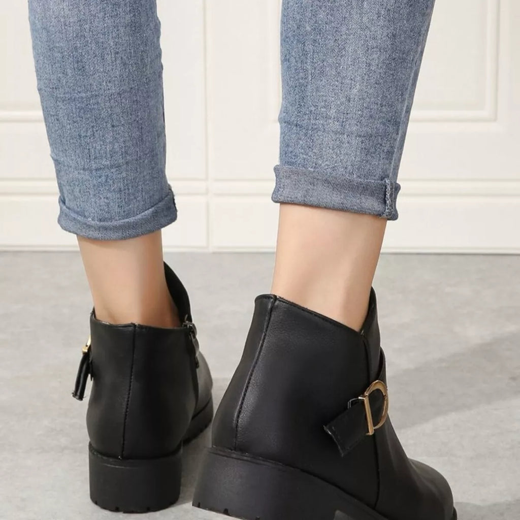 Black ankle boots back view with zipper closure and chunky rubber sole