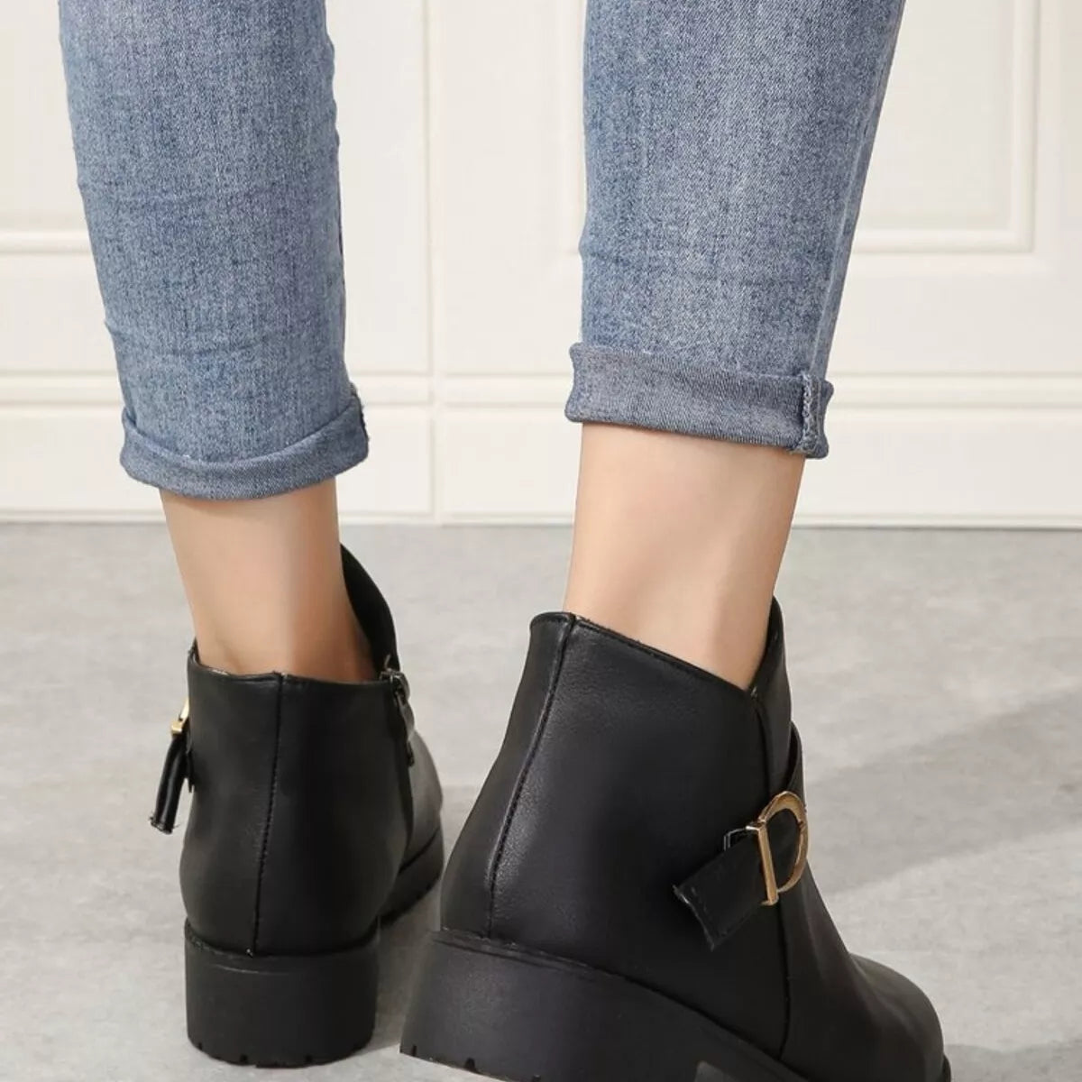 Black ankle boots back view with zipper closure and chunky rubber sole