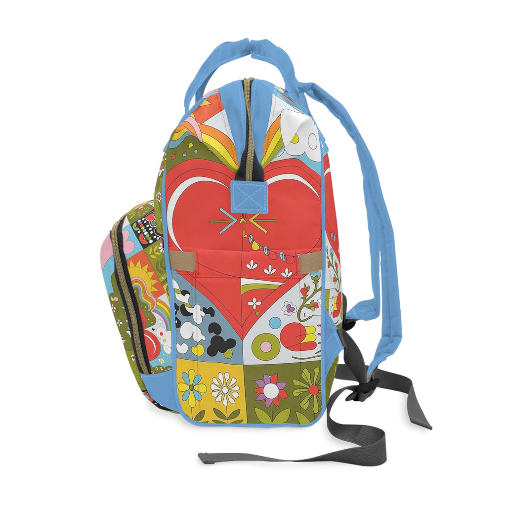Diaper backpack with rainbow heart patchwork front, side straps and black shoulder strap