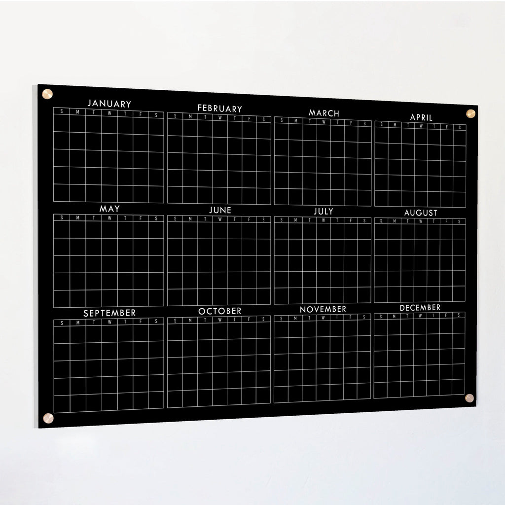 Black acrylic yearly calendar board with horizontal monthly grid and corner grommets