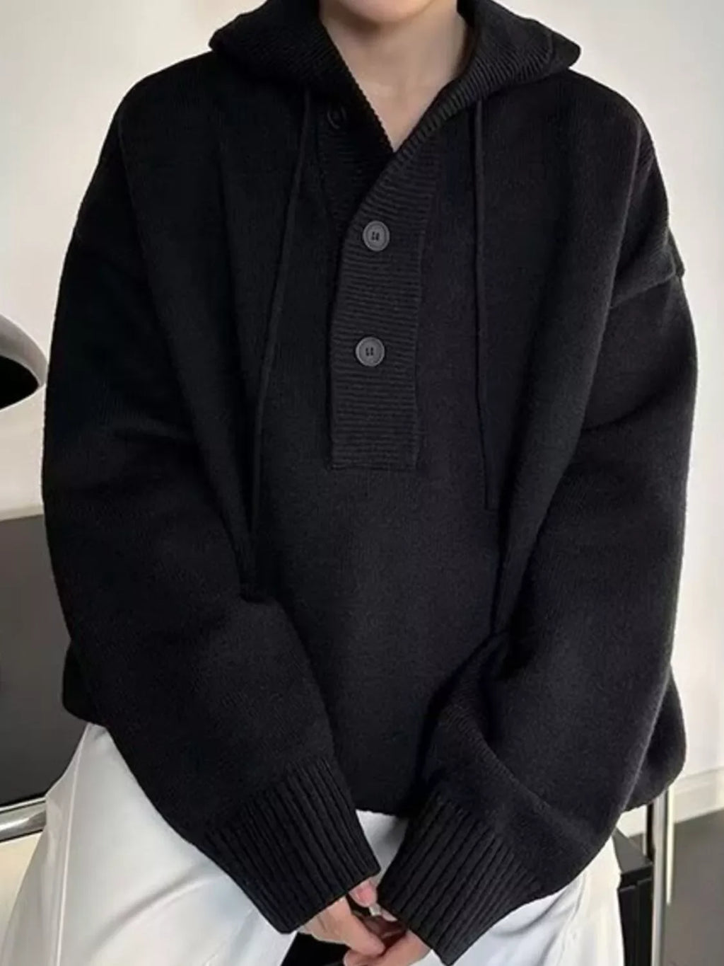 Black knit hooded button sweater with ribbed cuffs and hem