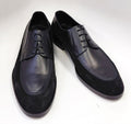 Black leather oxford shoes with lace-up front and stitched toe cap.
