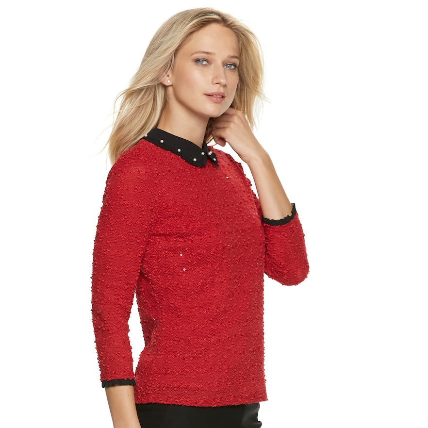 Red 3/4-sleeve collared top with black studded neckline and button trim.
