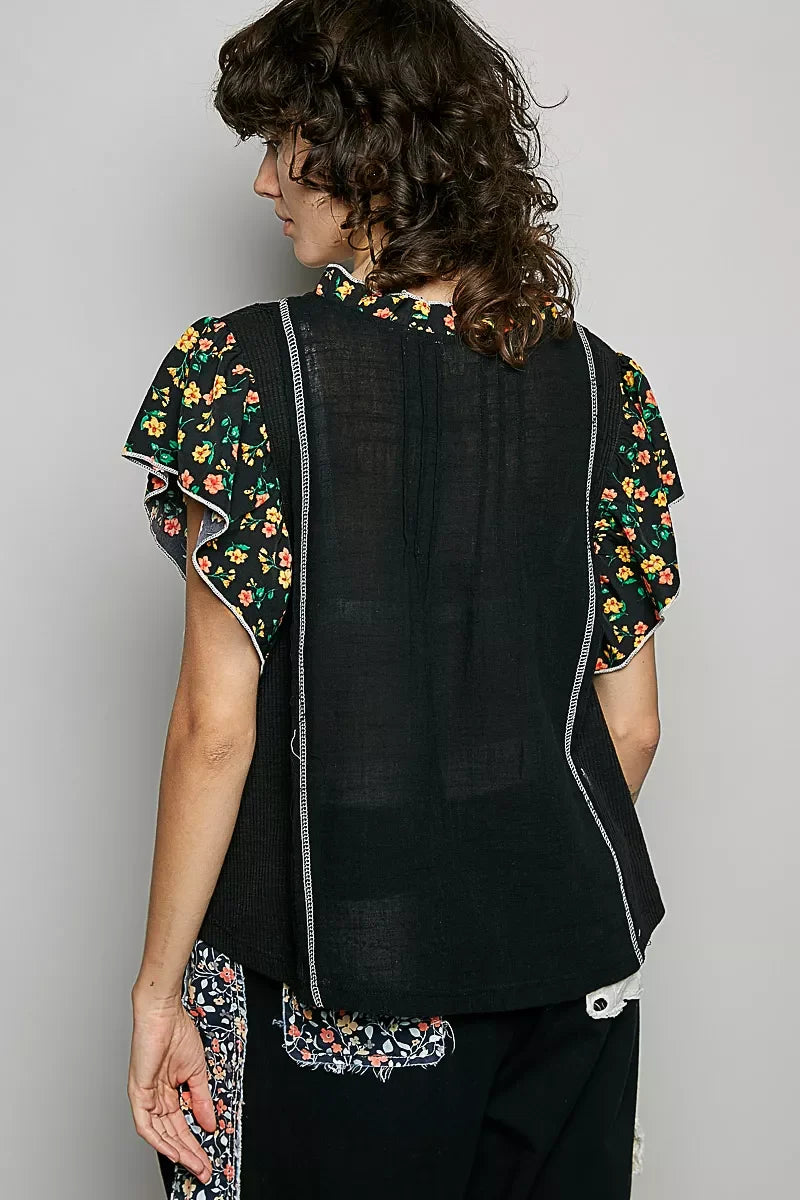Back view of black V-neck floral ruffle sleeve blouse with vertical trim