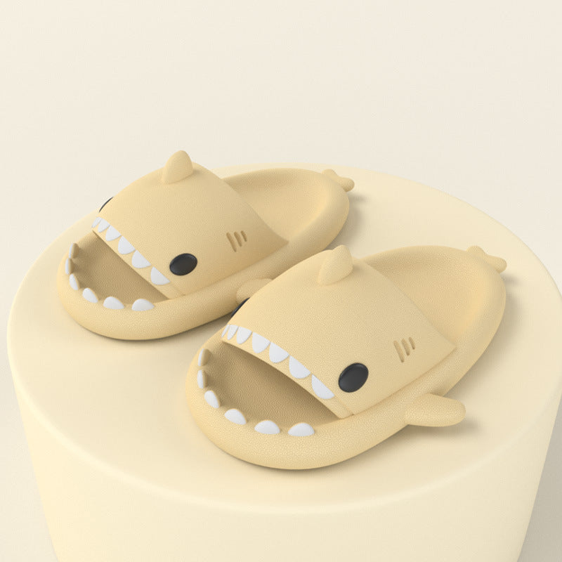 Light yellow shark slide sandals, open toe with white tooth detail and small fin