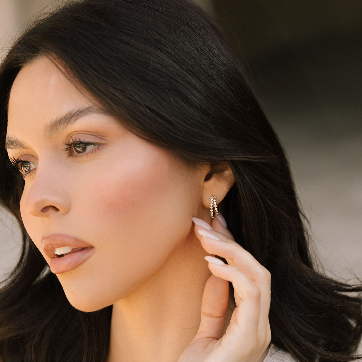 Double pave hoop earrings on woman, small gold hoops with clear stones