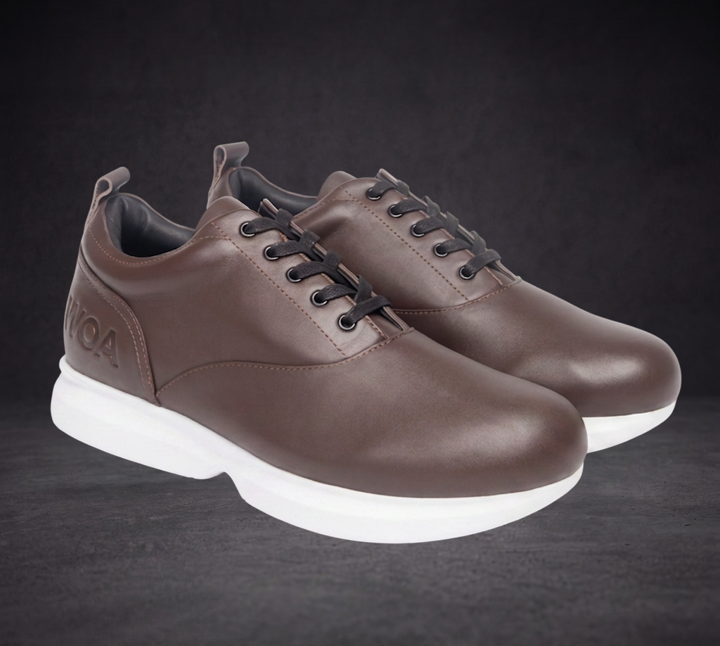 Pair of WOA brown low-top sneakers, lace-up with white soles, front three-quarter view