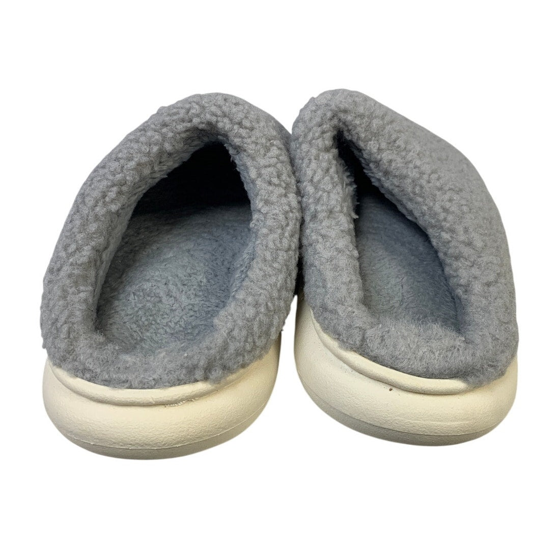 Gray fuzzy slippers with round toe and visible dark interior lining