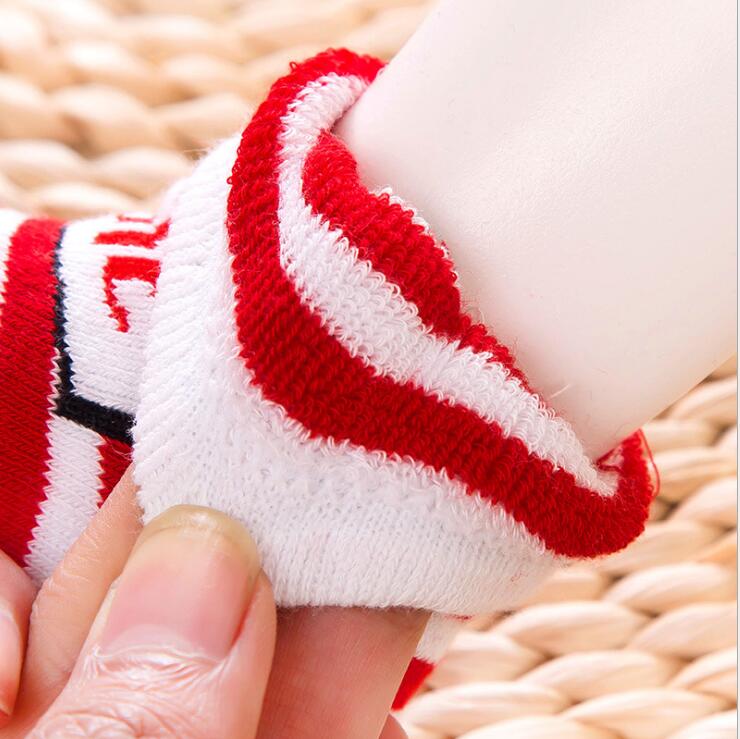 Children's cotton Christmas sock with red-and-white striped knit cuff detail