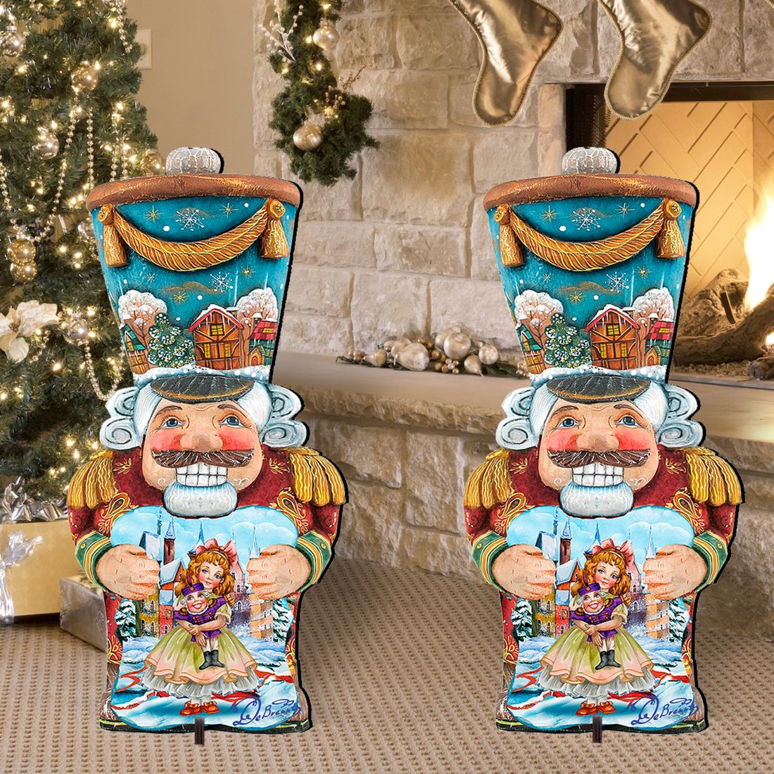 Pair of painted nutcracker yard decorations with blue tops, red coats, holding dolls