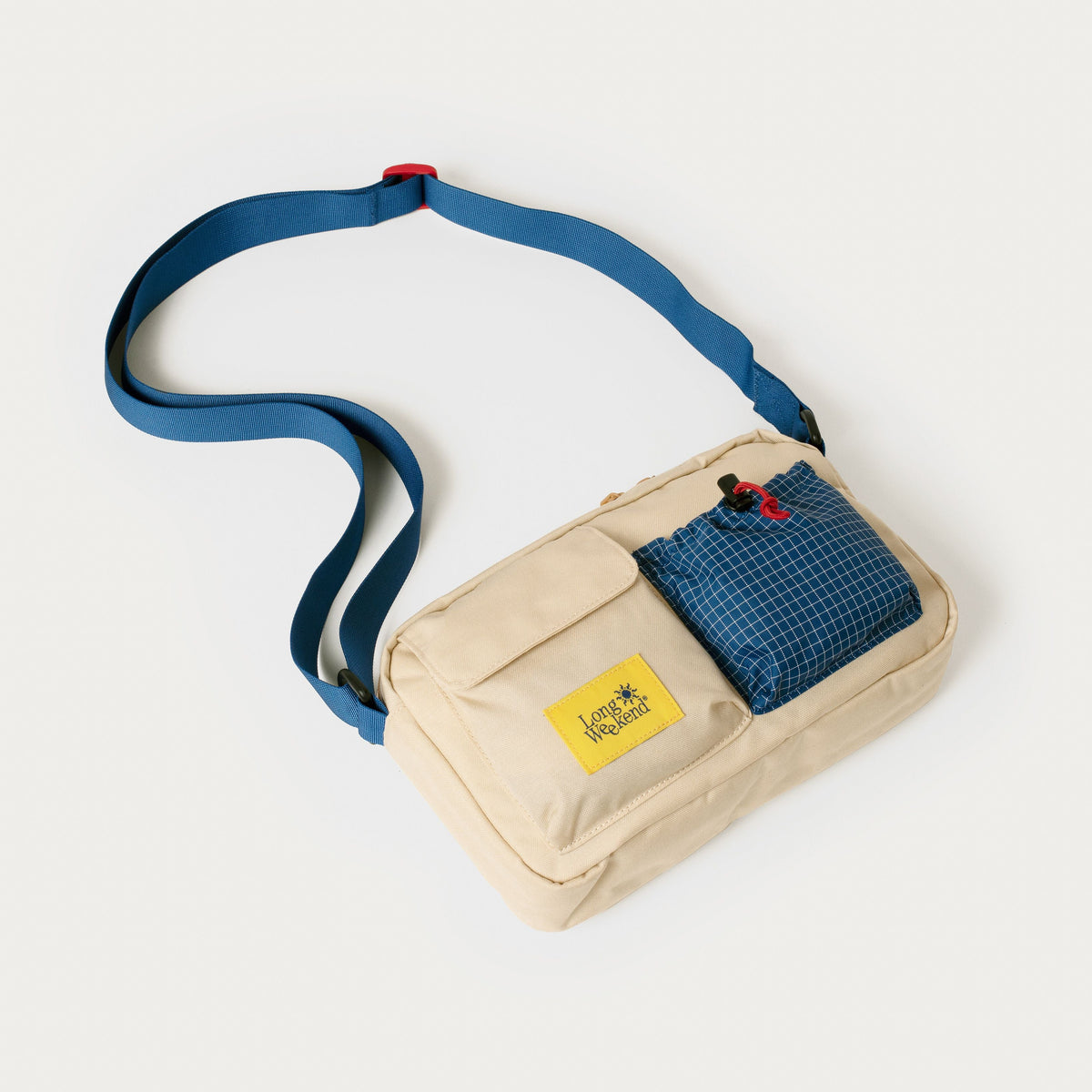 Cream shoulder bag with blue strap and zip front pocket, Long Weekend patch