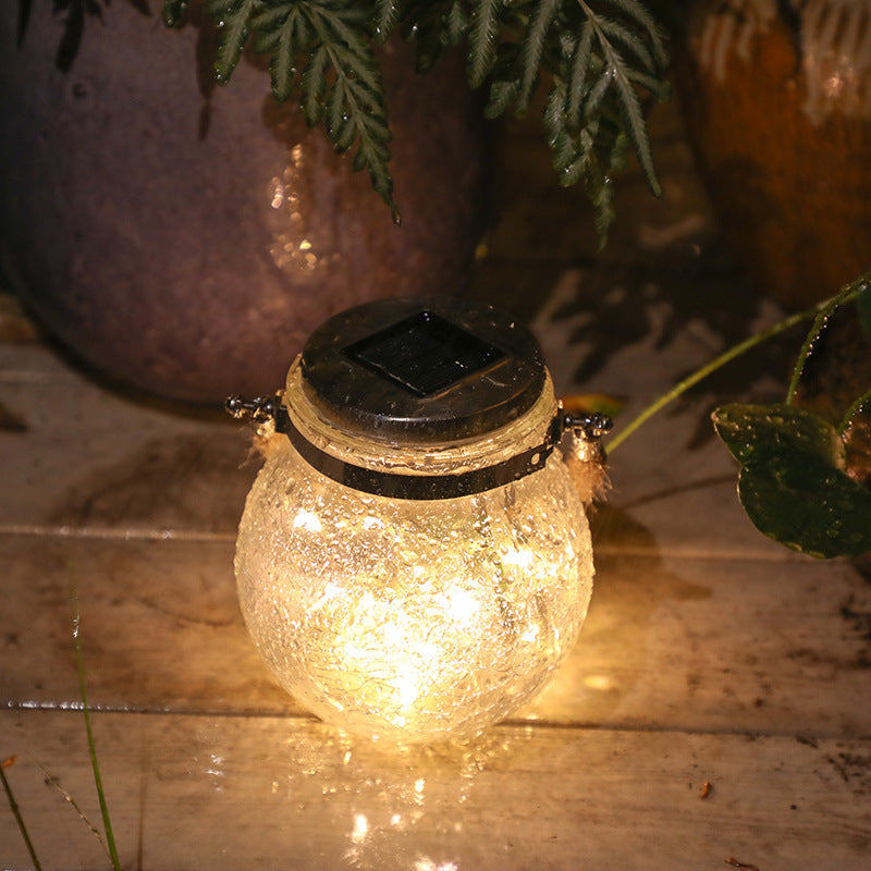 Crackle glass jar light with black cap and warm glow