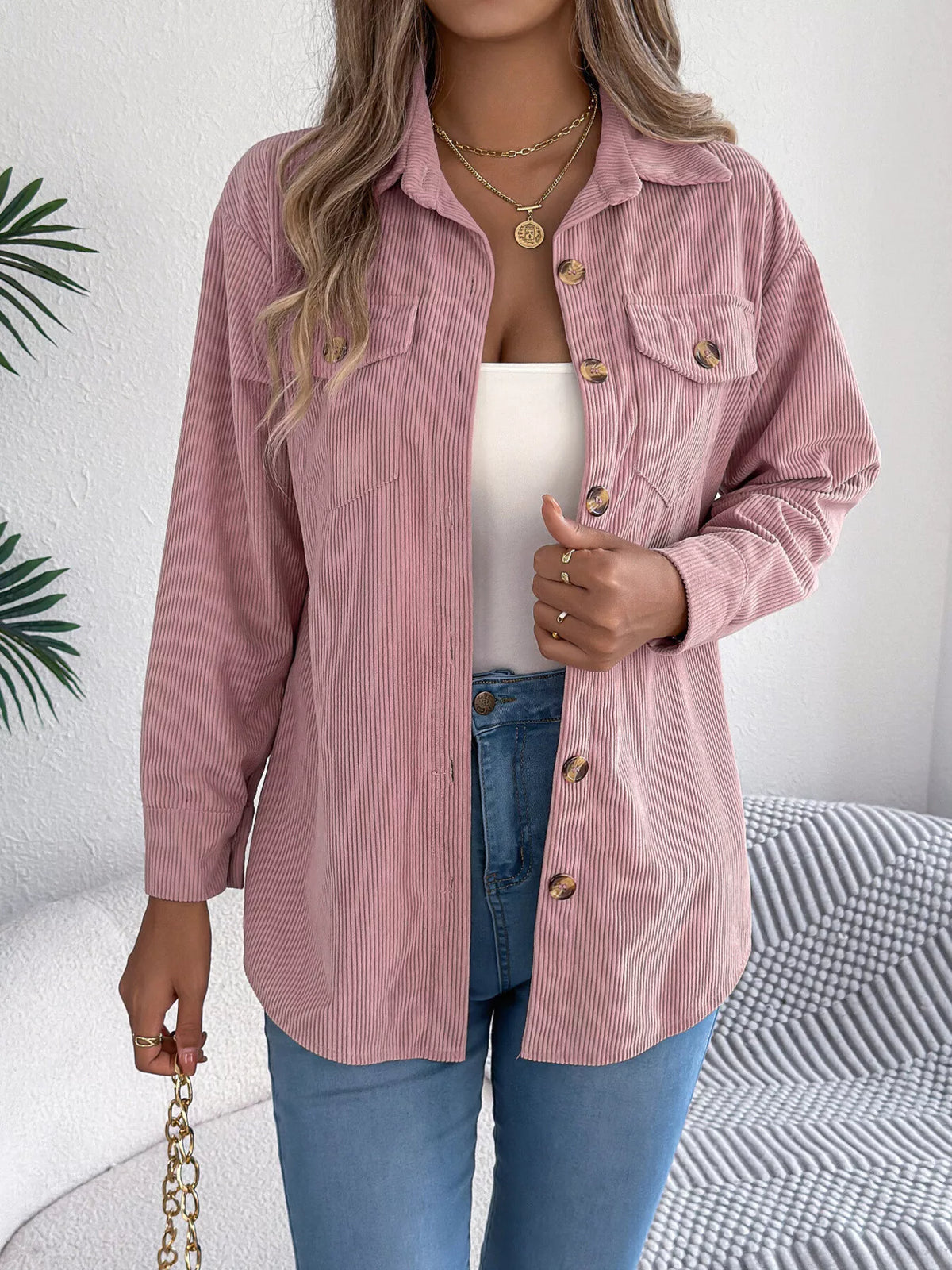 Pink corduroy button-up shacket, chest flap pockets and gold buttons at front