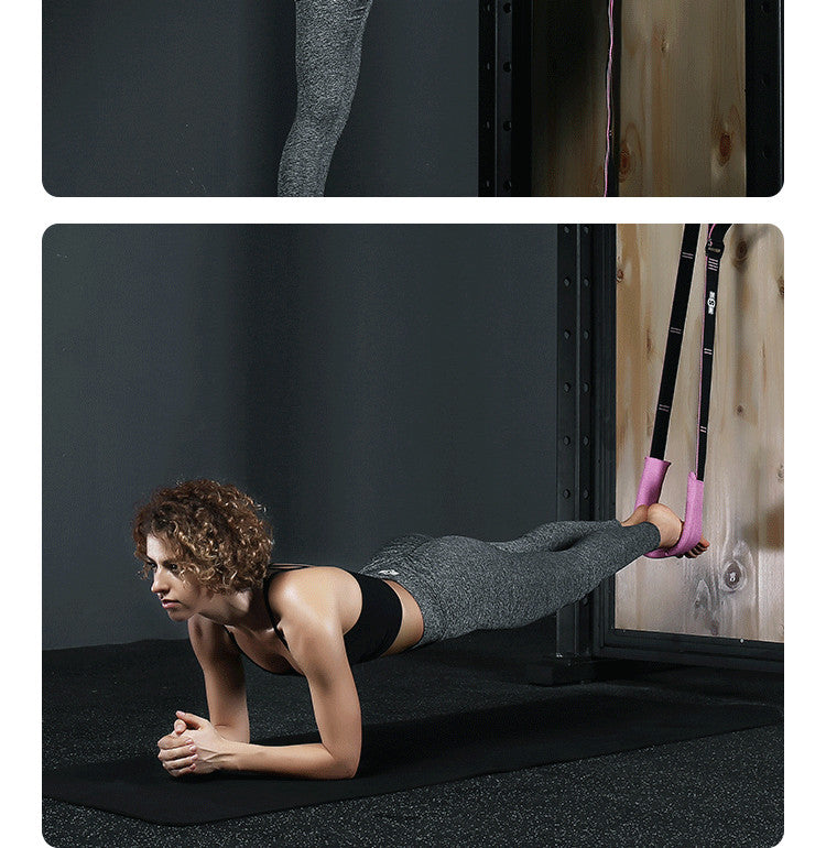 Pink yoga stretch band wrapped to assist a floor stretch exercise